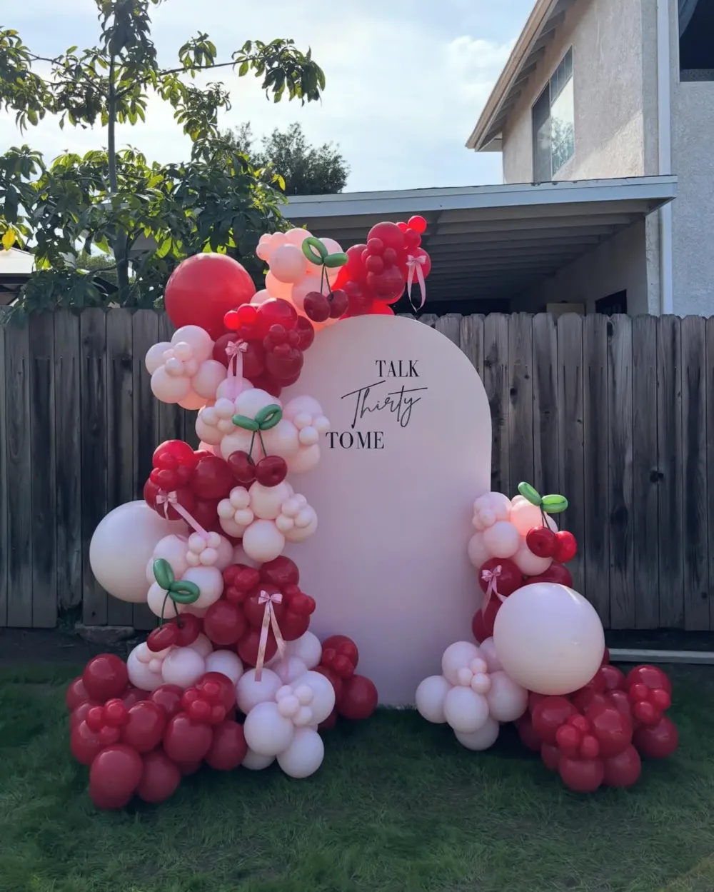 Talk Thirty To Me cherry themed 30th birthday balloon arch